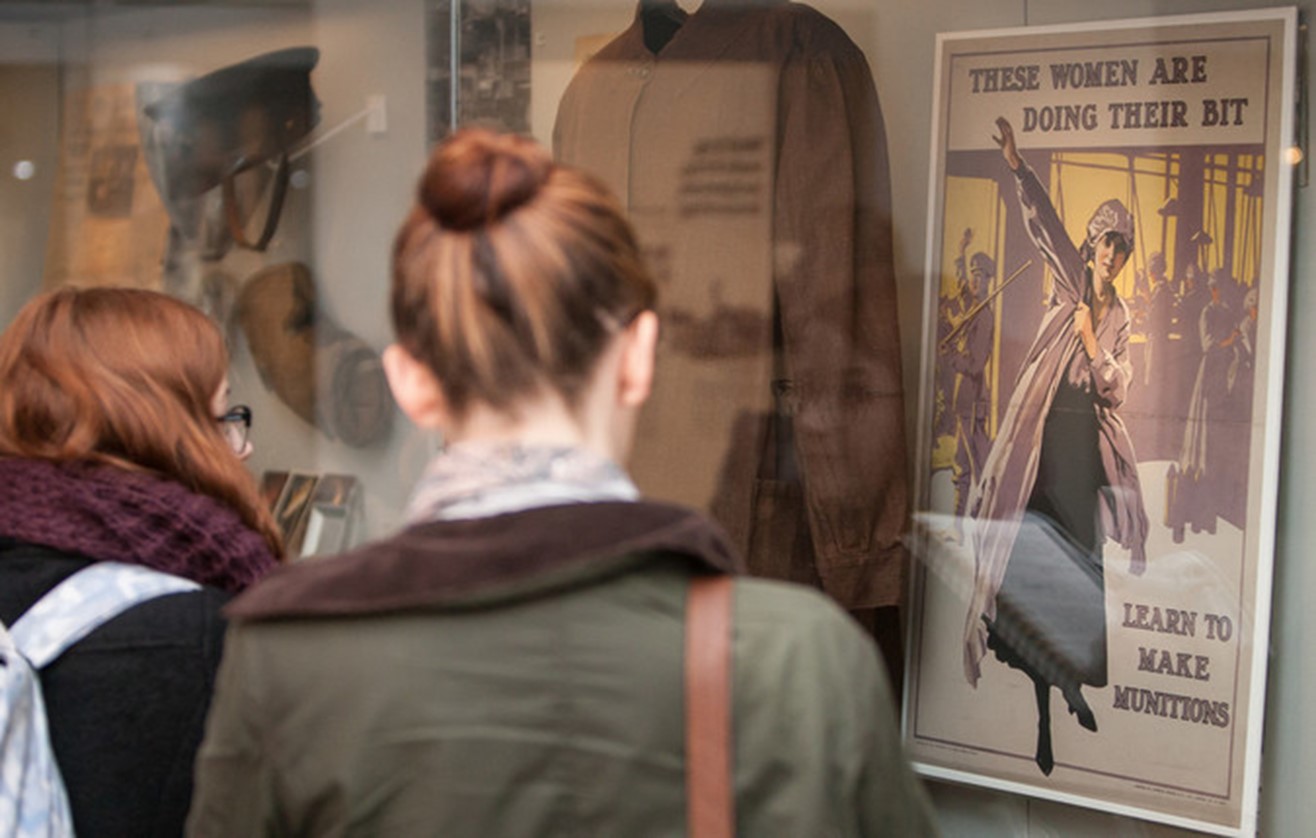 girl looking at poster in museum
