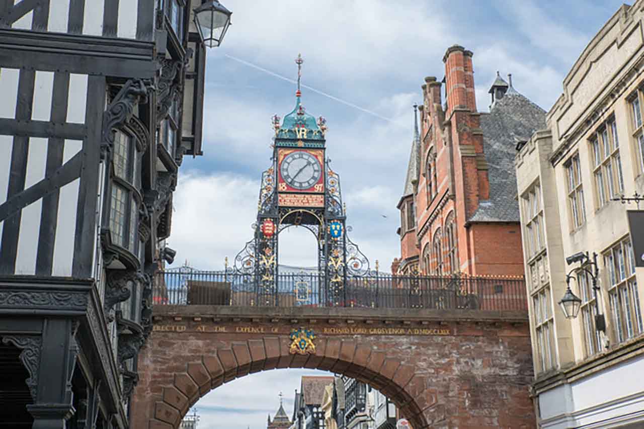 Chester city clock, old buildings and roman walls.