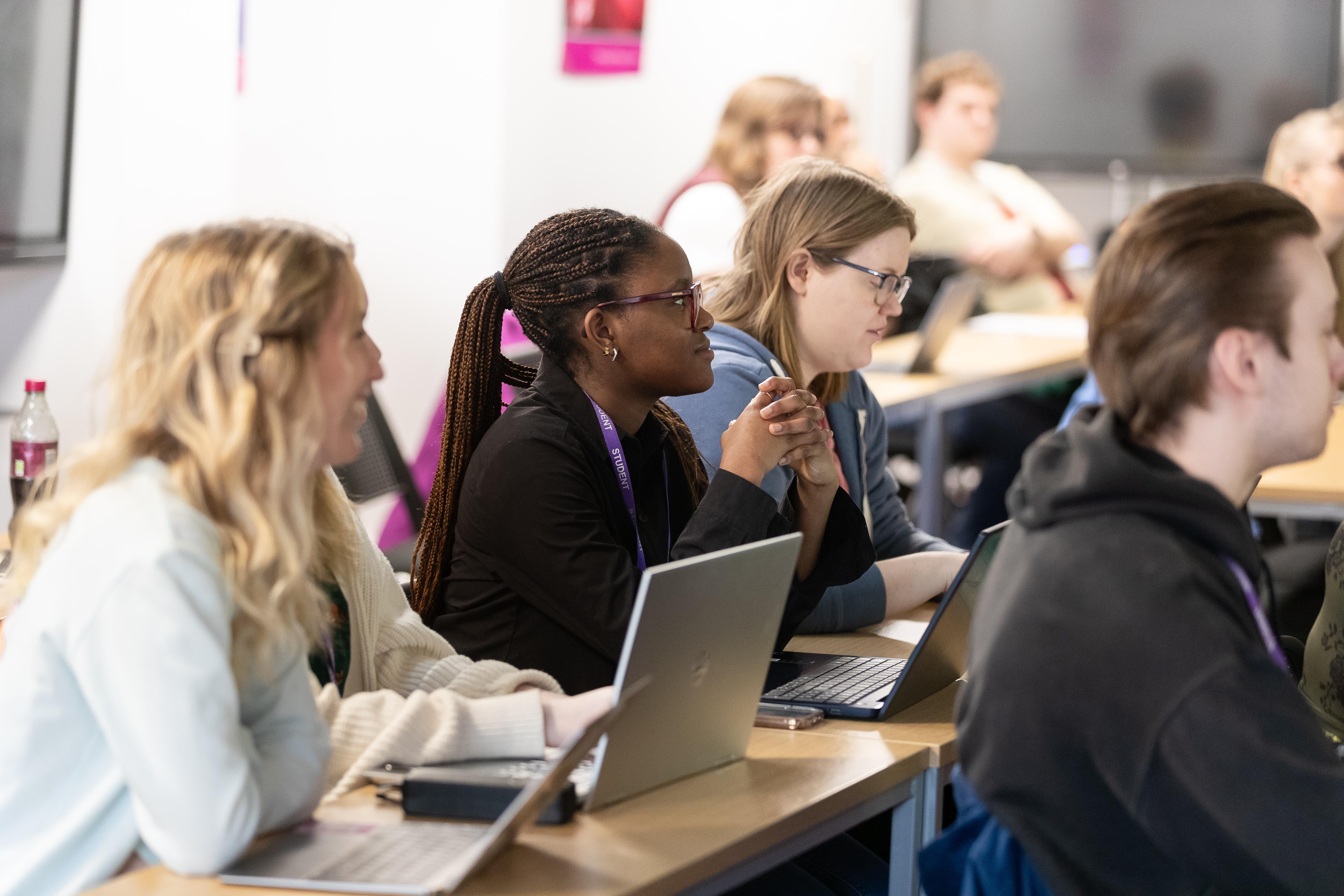 Postgraduate students on the TESOL with CELTA MA course take part in a university seminar, using laptops and engaging in language teaching and learning discussions. The course combines a Master's in Teaching English to Speakers of Other Languages with the internationally recognised CELTA qualification.