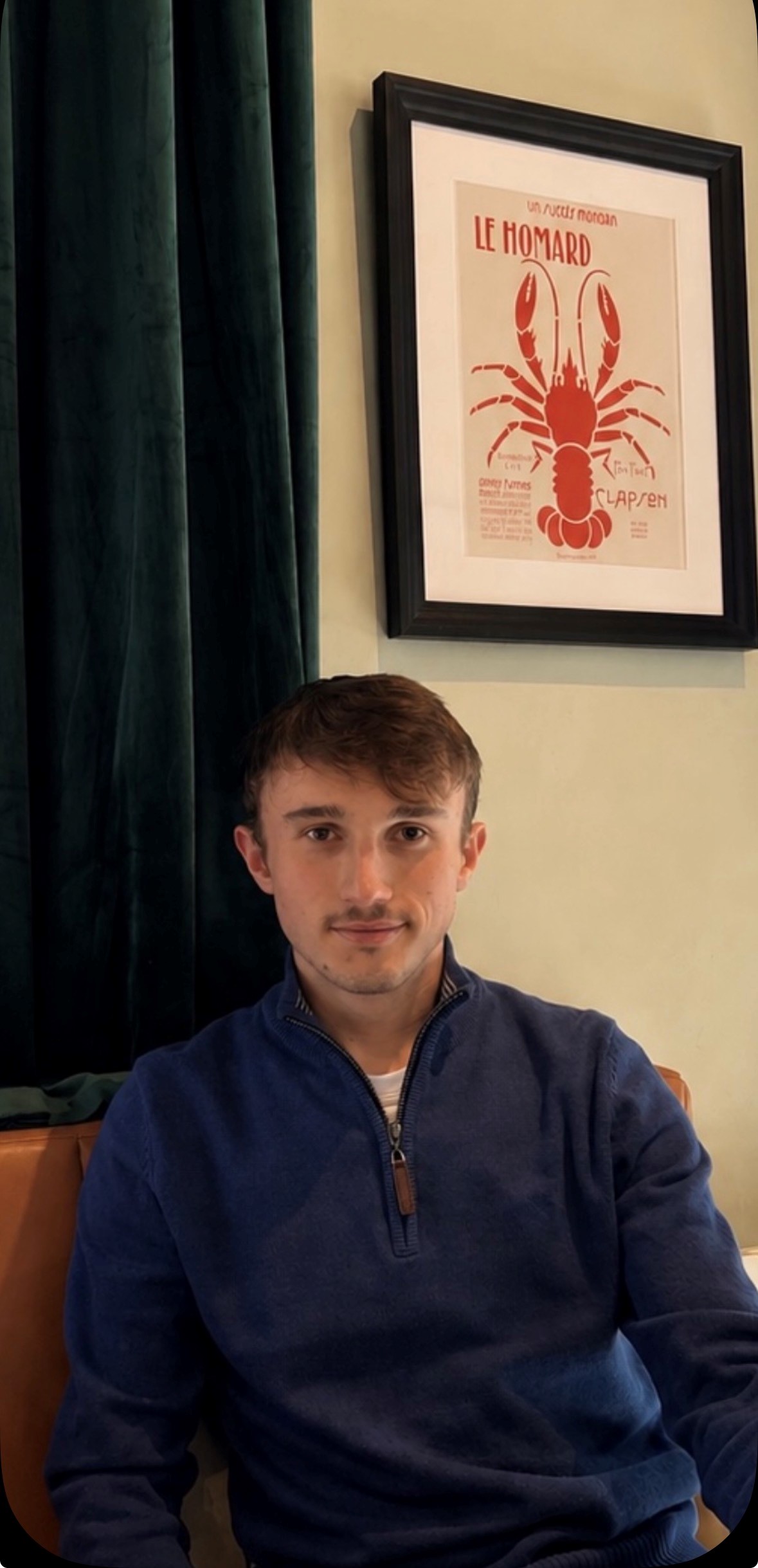 Student Will sat in front of a photo frame