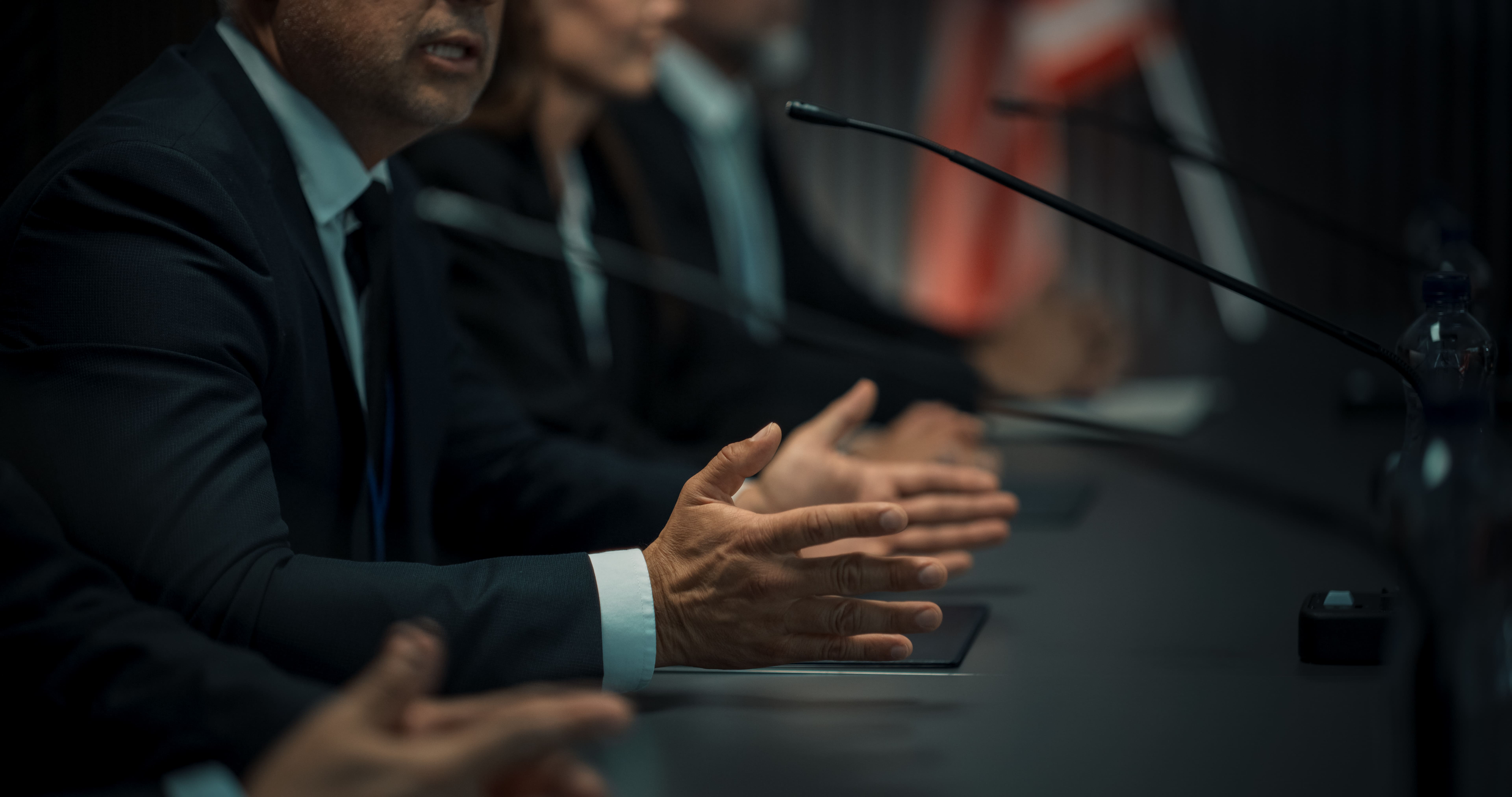 Close Up On Hands of Male Organization Representative Speaking at Conference