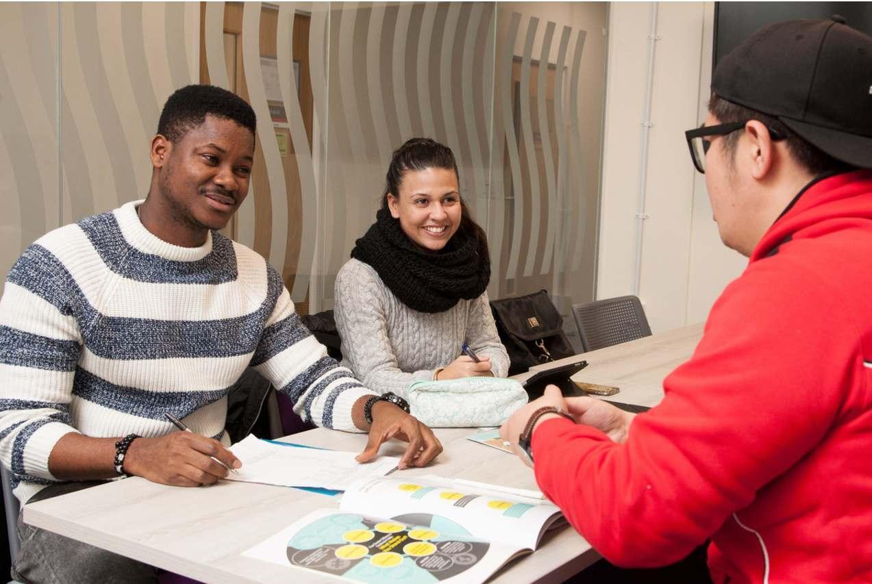 Engaged Marketing BA students collaborating on real-world projects in a dynamic learning environment, preparing for successful careers in marketing and business.