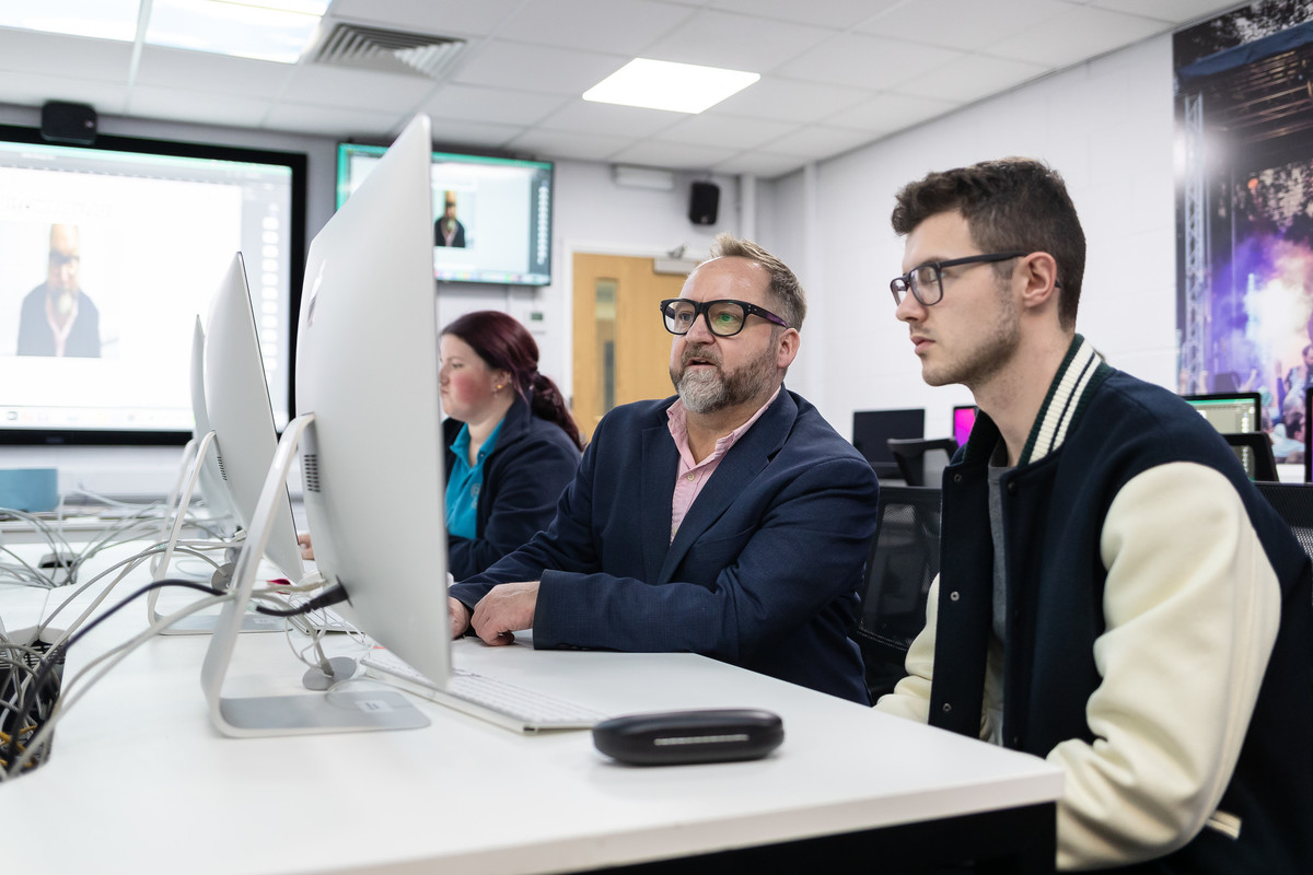 Media students at work in front of computer screens.