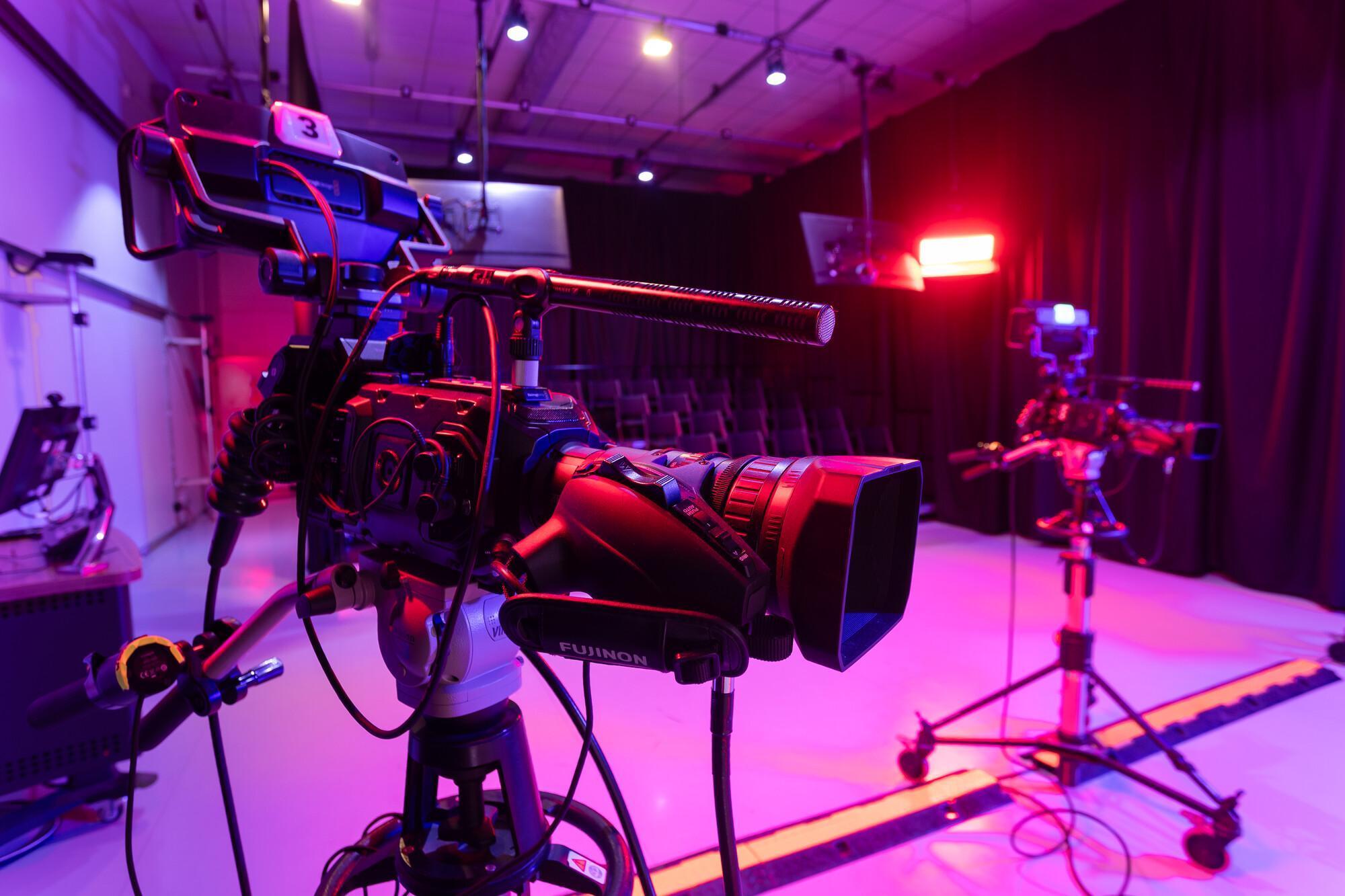 Professional television studio setup with high-definition cameras and creative lighting, representing hands-on film production, media technology, and visual storytelling in a Film and Media Studies BA (Hons) course.