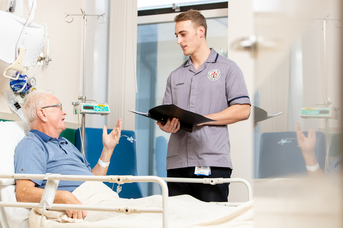 male adult nursing student with patient