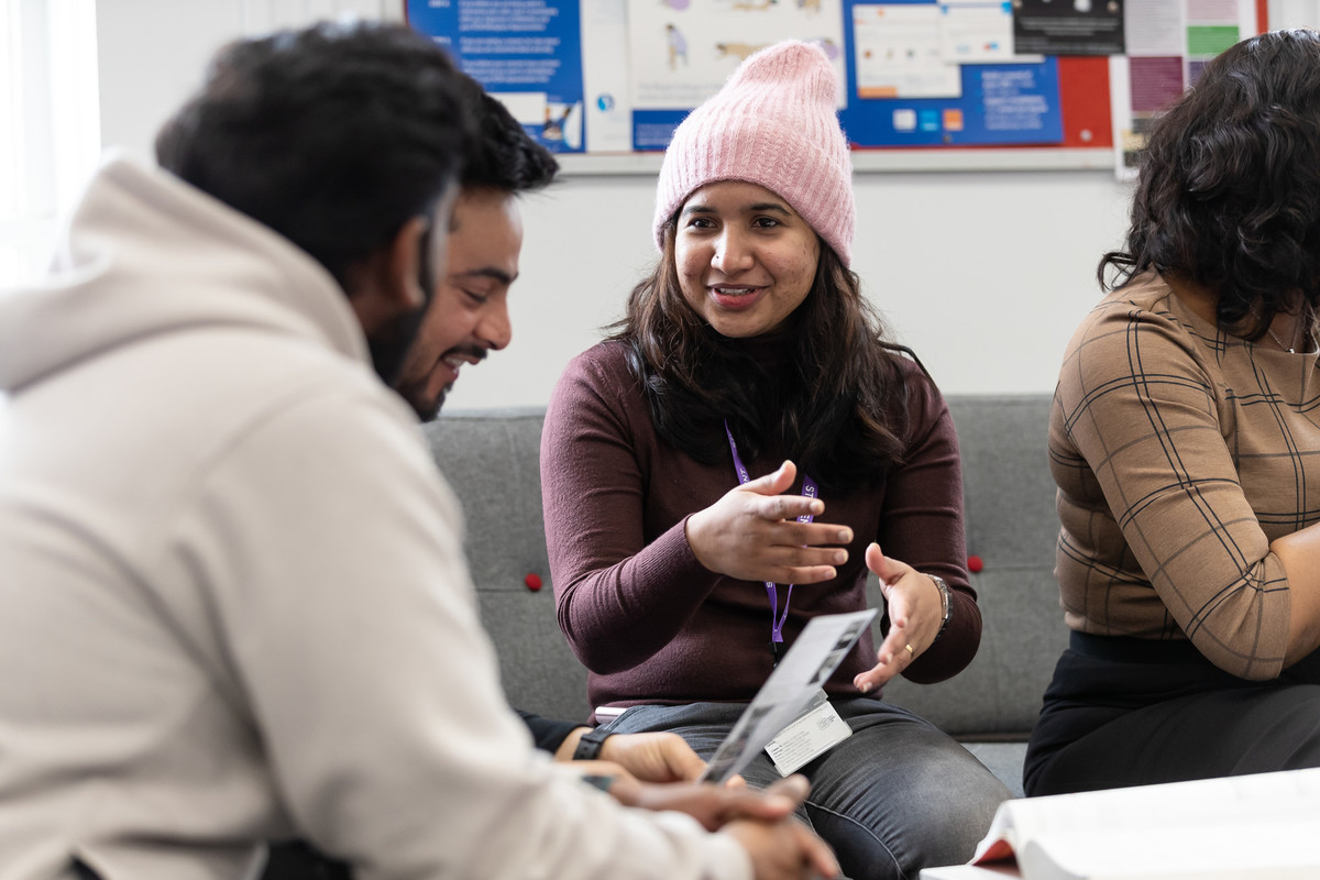 students talking in front of laptop