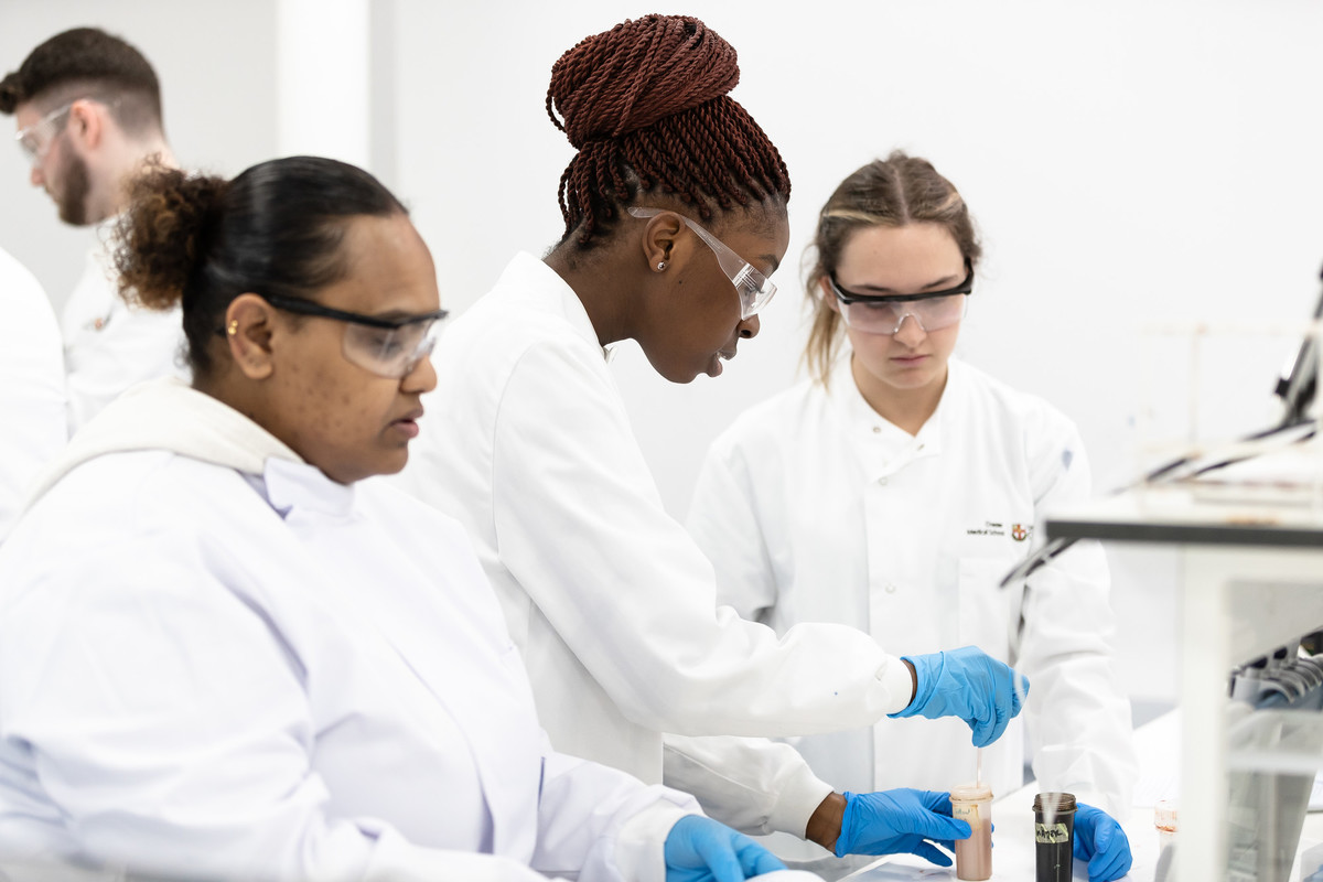 A group of female students on the BSc Biomedical Science degree, learning essential laboratory skills training and research.
