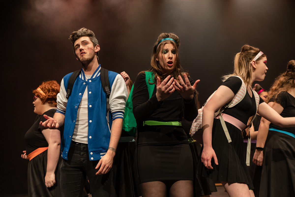 students performing on stage