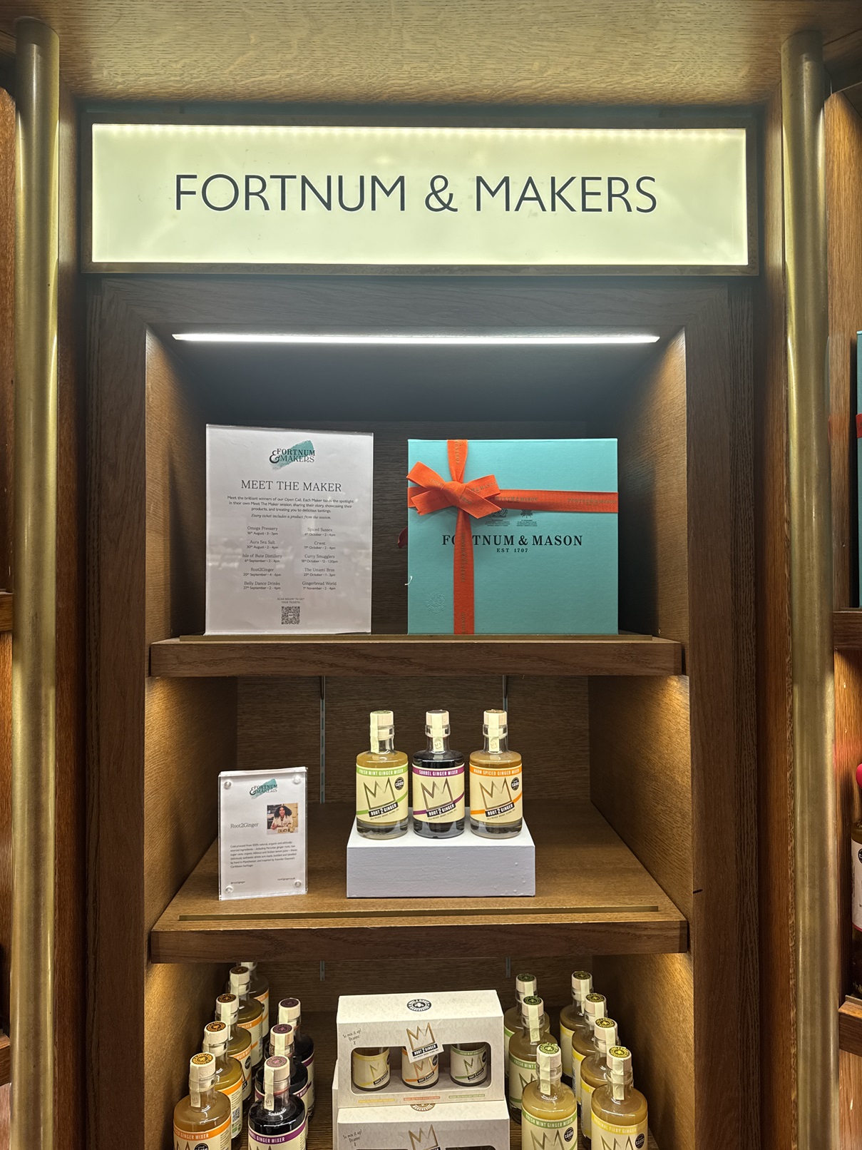A selection of Root2Ginger products on shelves under the display name 'Fortnum &