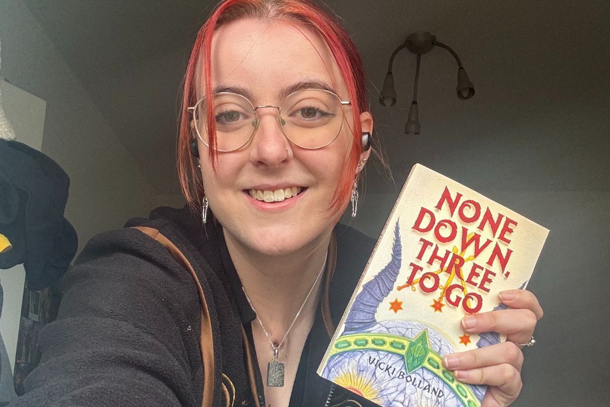 Vicki Bolland holding a copy of her debut book.