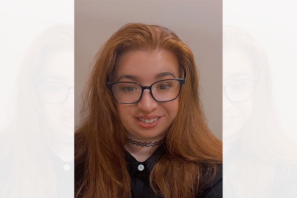 A head and shoulders photo of Ruthie O'Brien looking at the camera, wearing glasses and smiling.