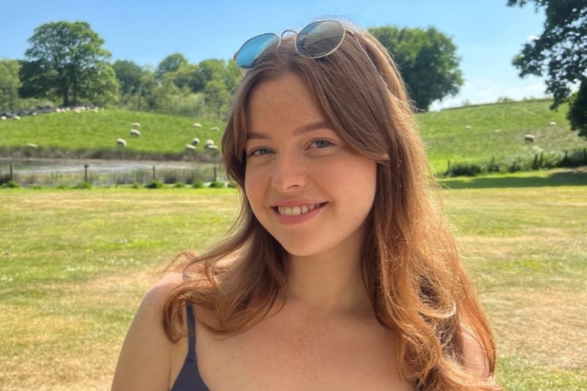 A head-and-shoulders photo of Kate Myers smiling at the camera while outside on a sunny day.