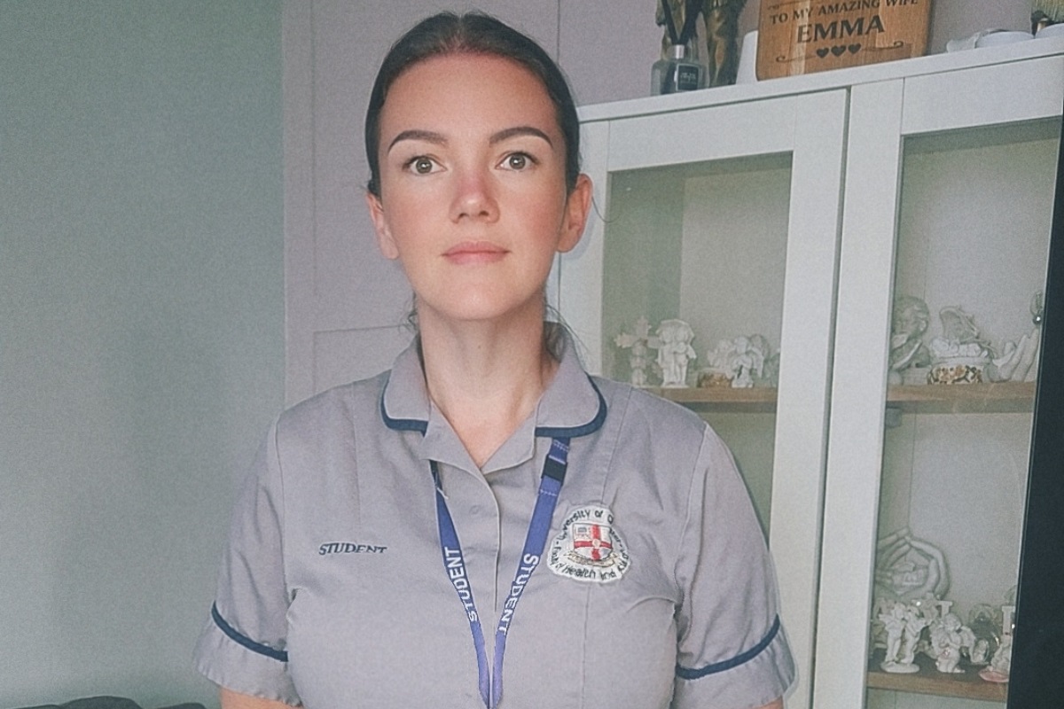 A woman in nursing uniform and a lanyard with 