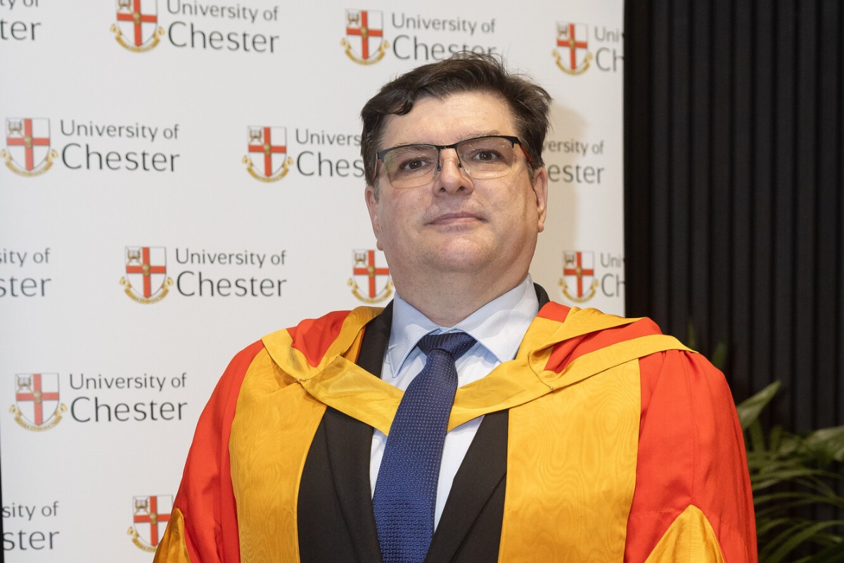 A head-and-shoulders photo of Prof Silvester Czanner in a gown. In the background is a banner featuring the University of Chester logo.