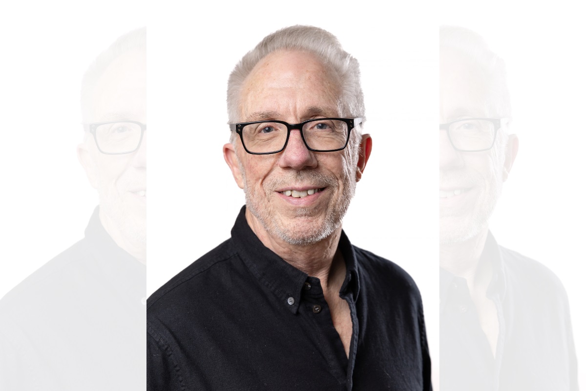 A head and shoulders photo of Colin Potts, wearing glasses, smiling and looking at the camera.