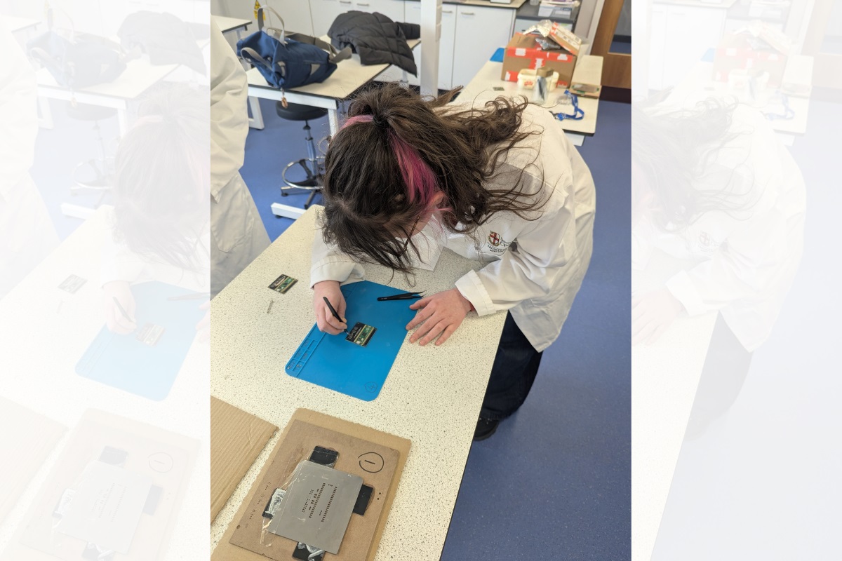 A participant making a Griff-Mini Bat Detector on a desk.