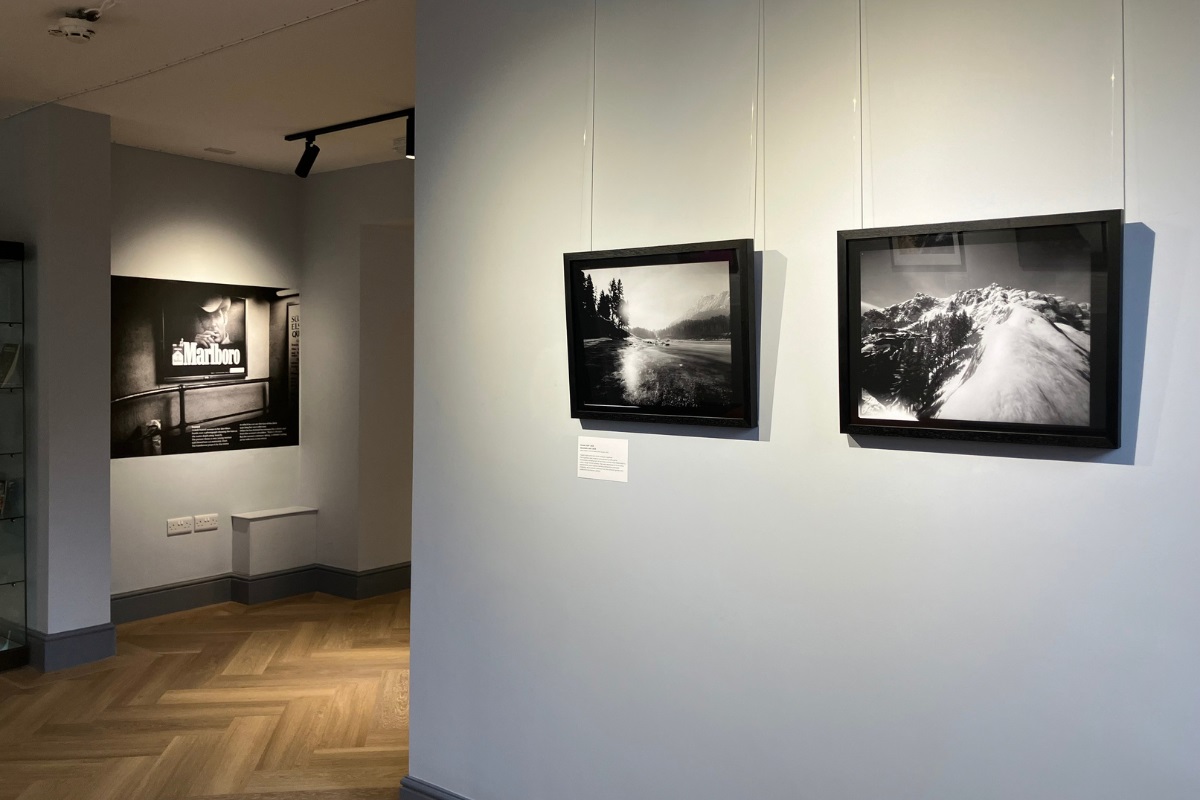 Framed monochrome photos on display in a gallery.
