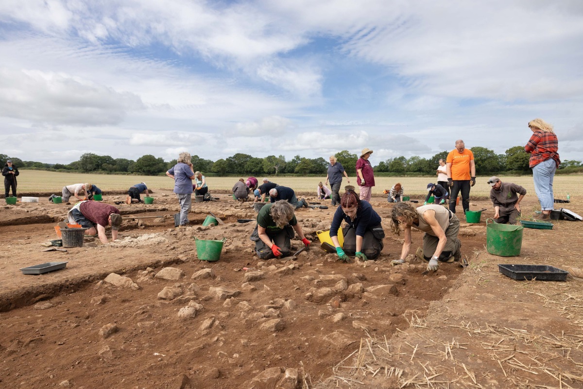 A group of people working away on an excavation site.