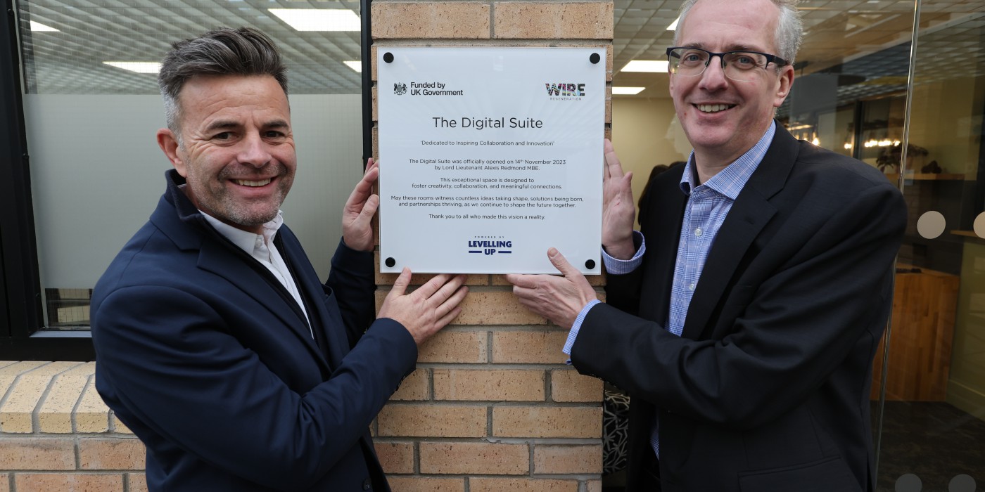 Two men standing in front of the Digital Suite plaque