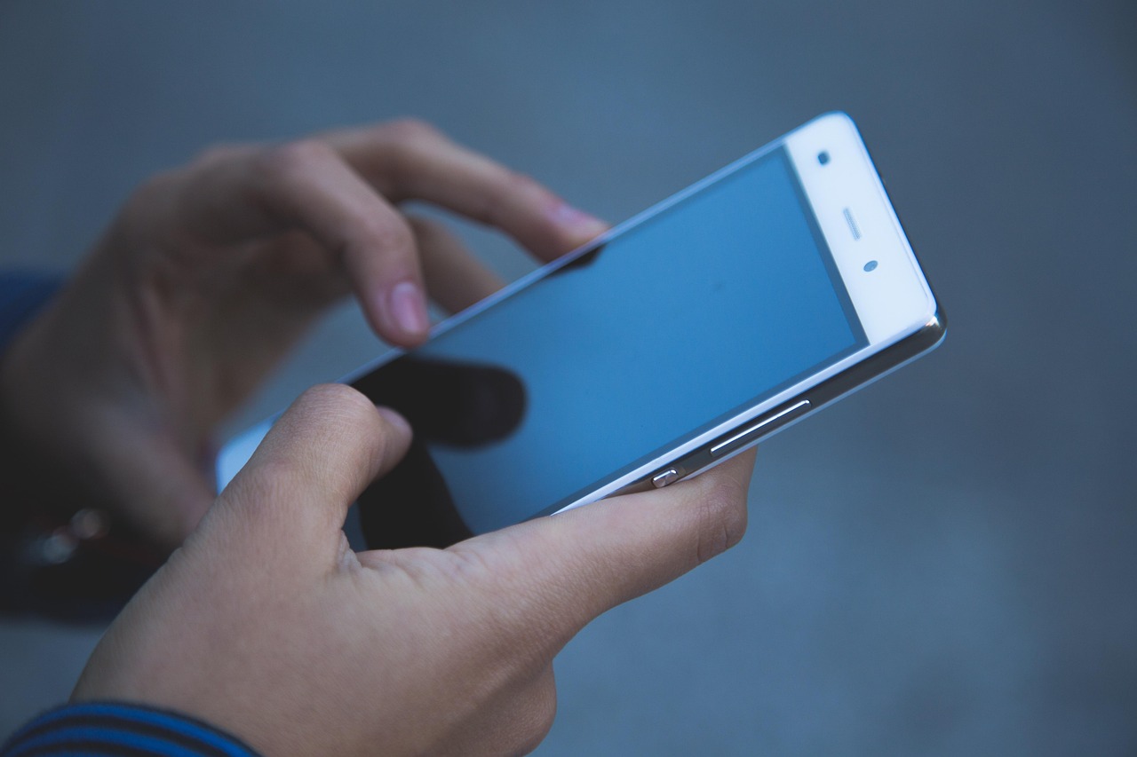 A mobile phone in hands.