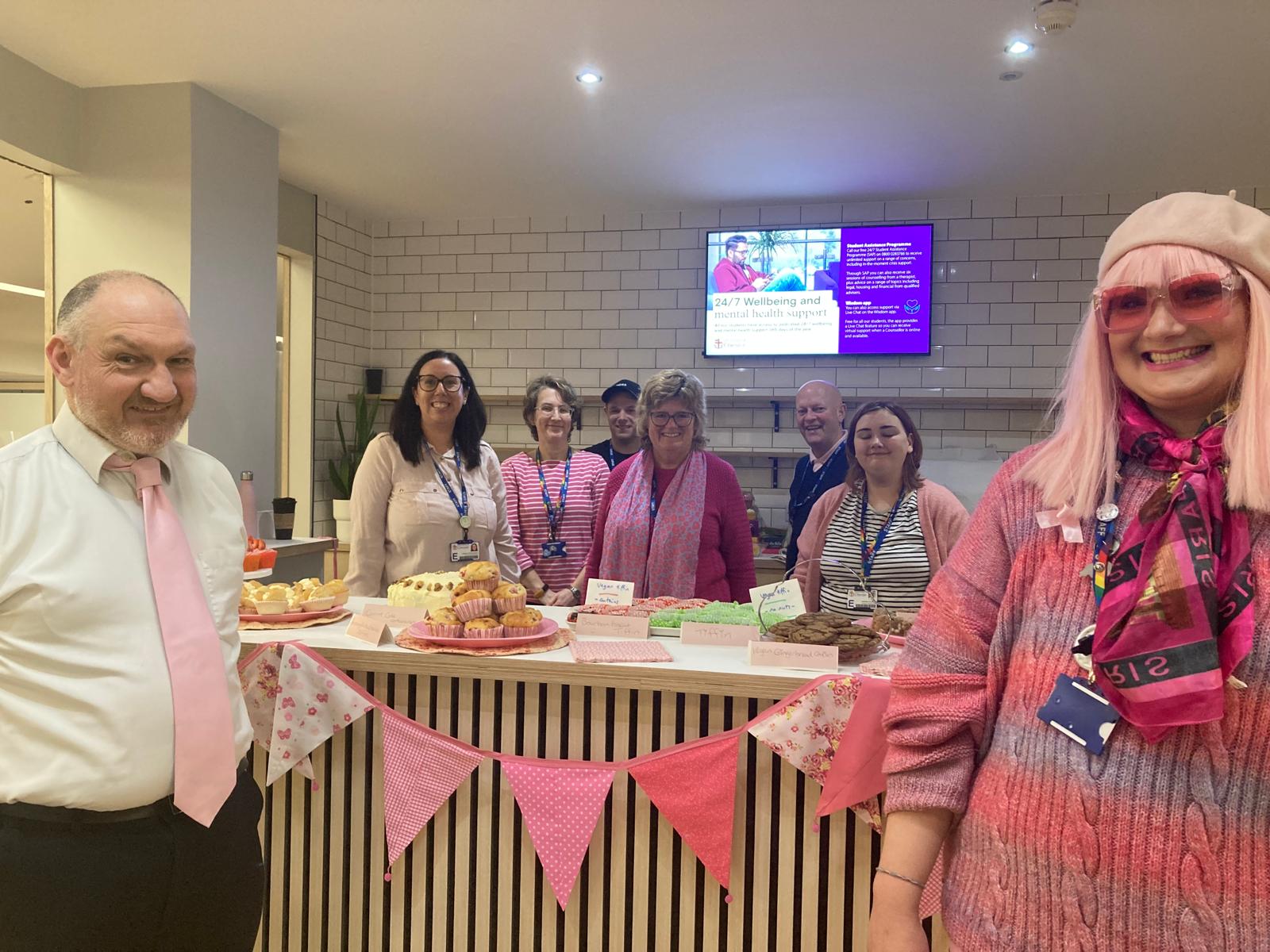Library staff at a cake stall.