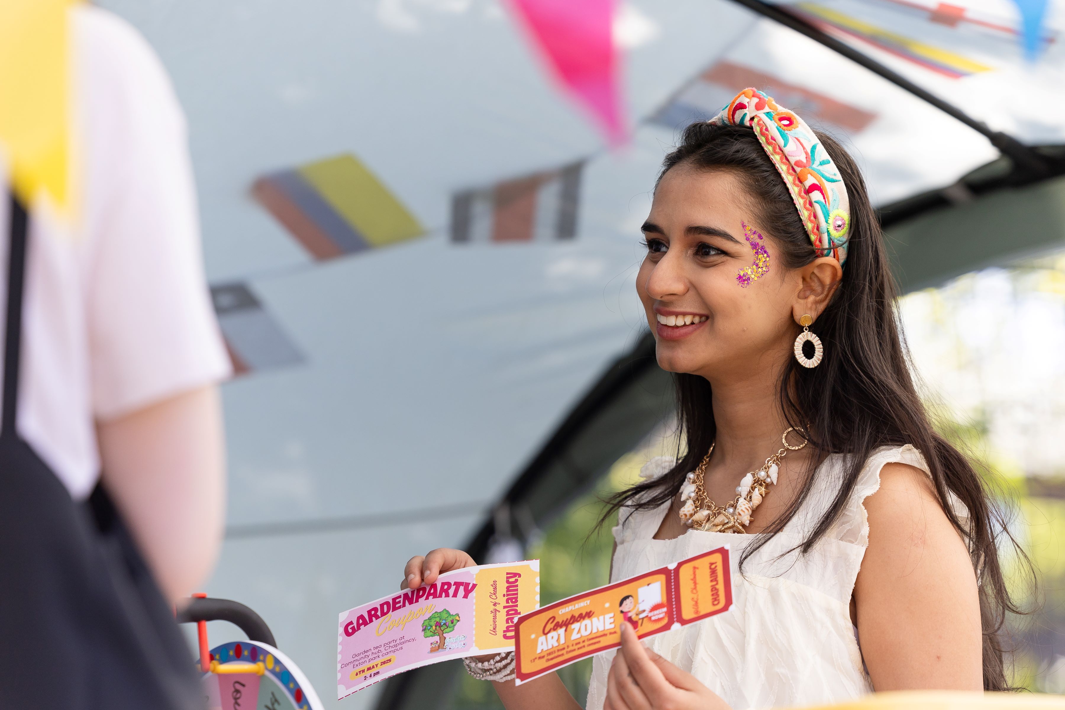 Ramitha at Chestival event handing out tickets for chaplaincy activities