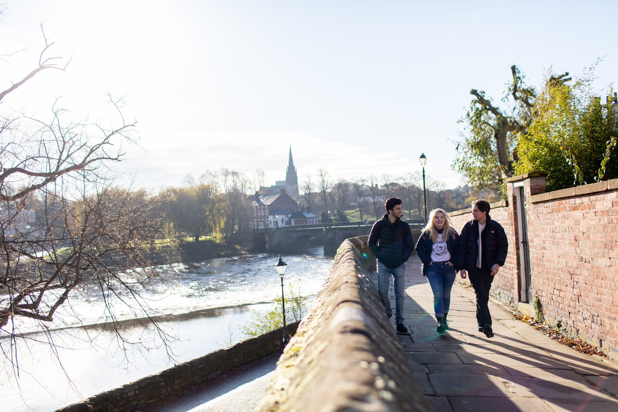 Students walking by the river.