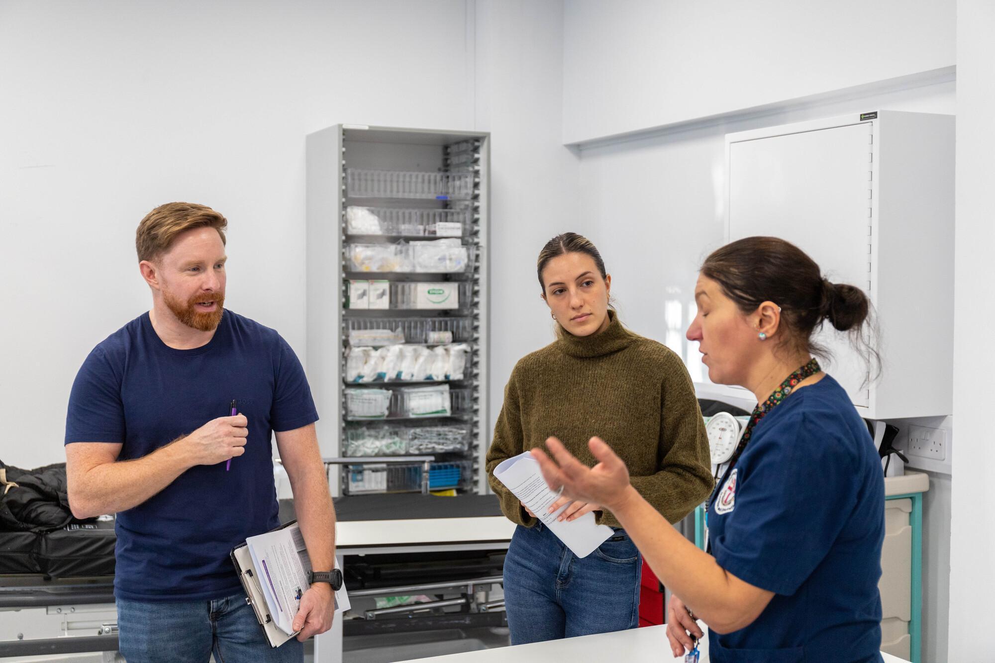 Healthcare professionals and students discussing patient care in a clinical skills environment, demonstrating lifestyle medicine, preventive healthcare, behaviour change and evidence-based approaches to improving long-term health on the Lifestyle Medicine MSc programme.