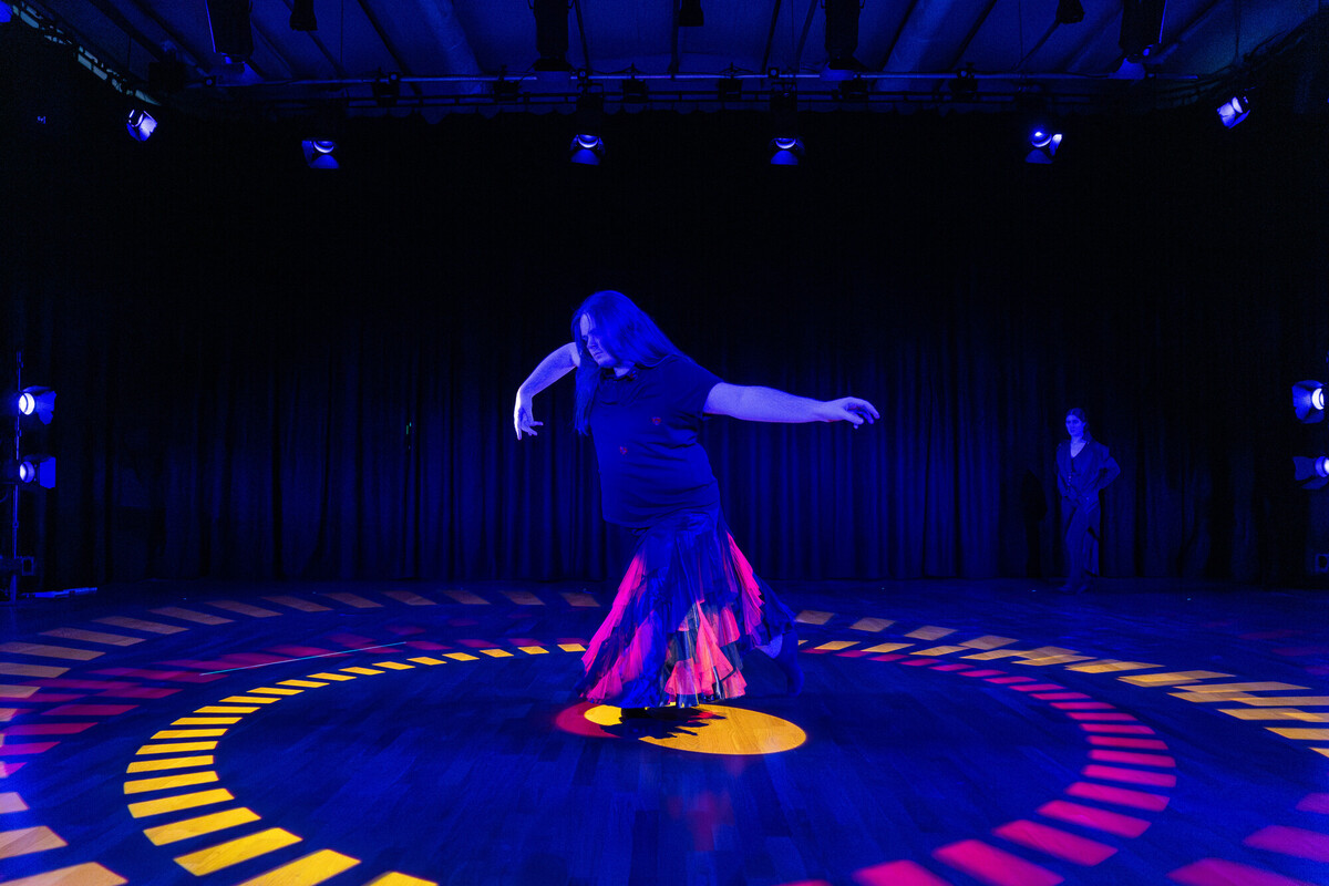 student on stage with eye-catching lighting