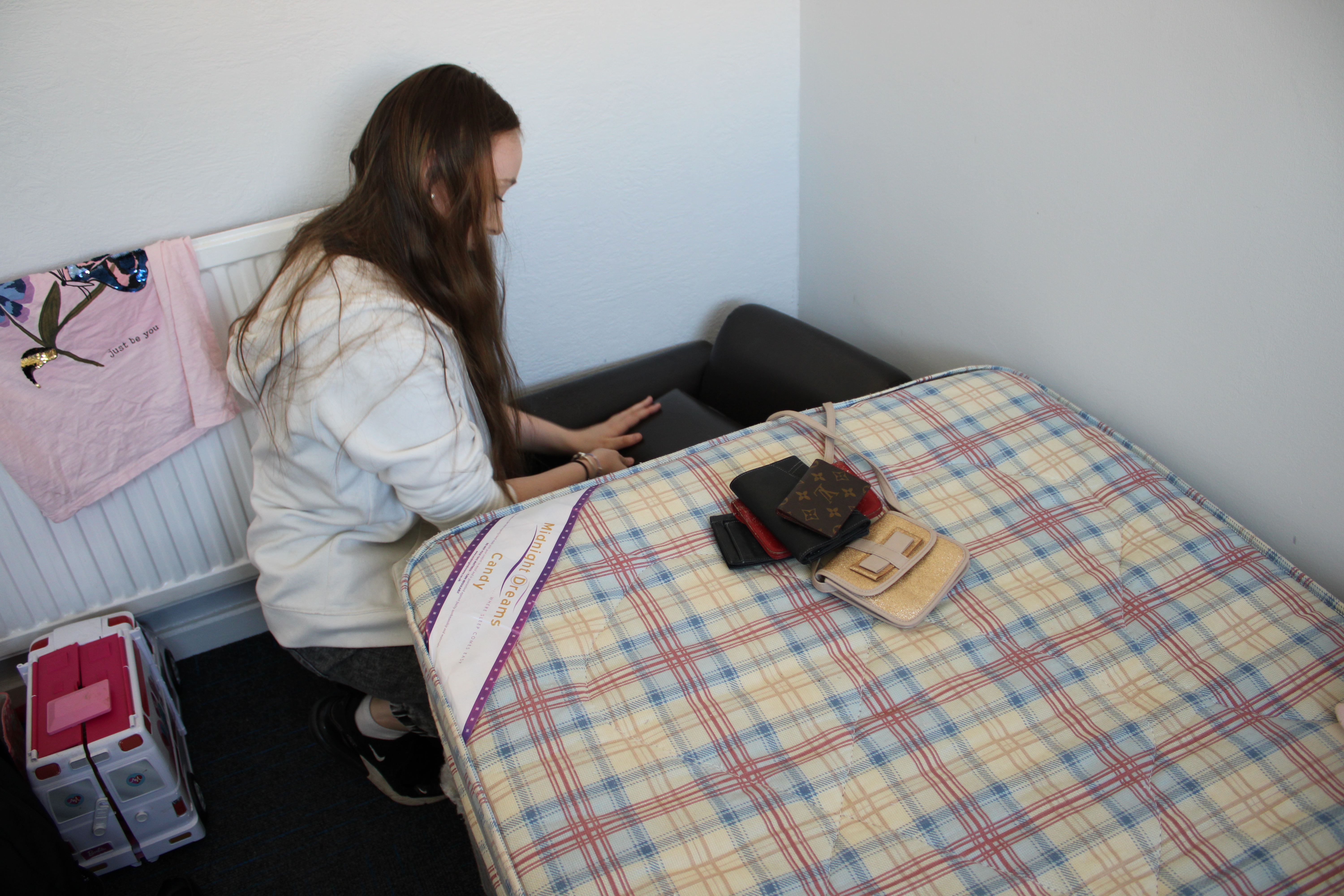 student looking under bed for evidence