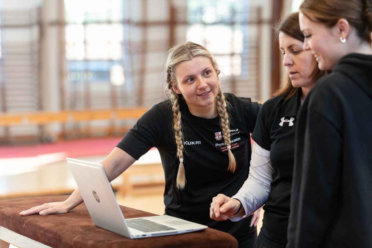 A group of students around a laptop