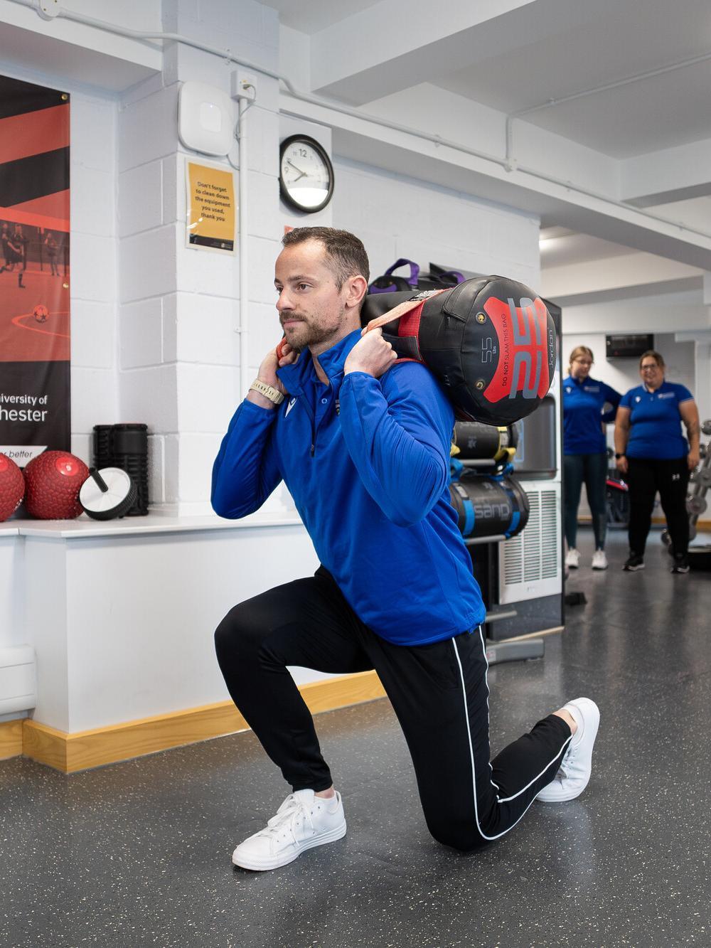 Health and Exercise Science BSc student performing functional strength training in a specialist sports science laboratory, developing expertise in exercise prescription, rehabilitation and health performance.