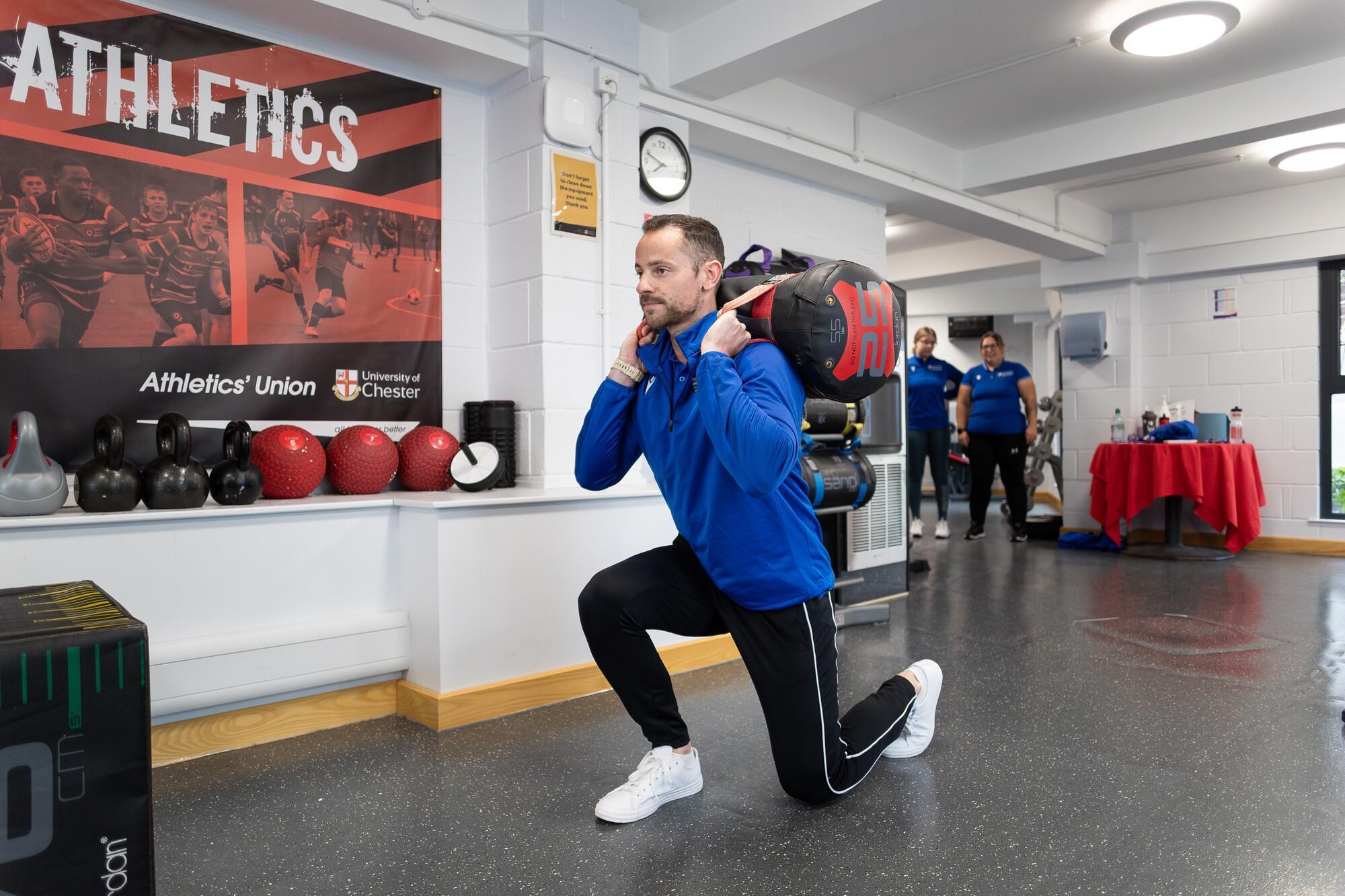 Health and Exercise Science BSc student performing functional strength training in a specialist sports science laboratory, developing expertise in exercise prescription, rehabilitation and health performance.
