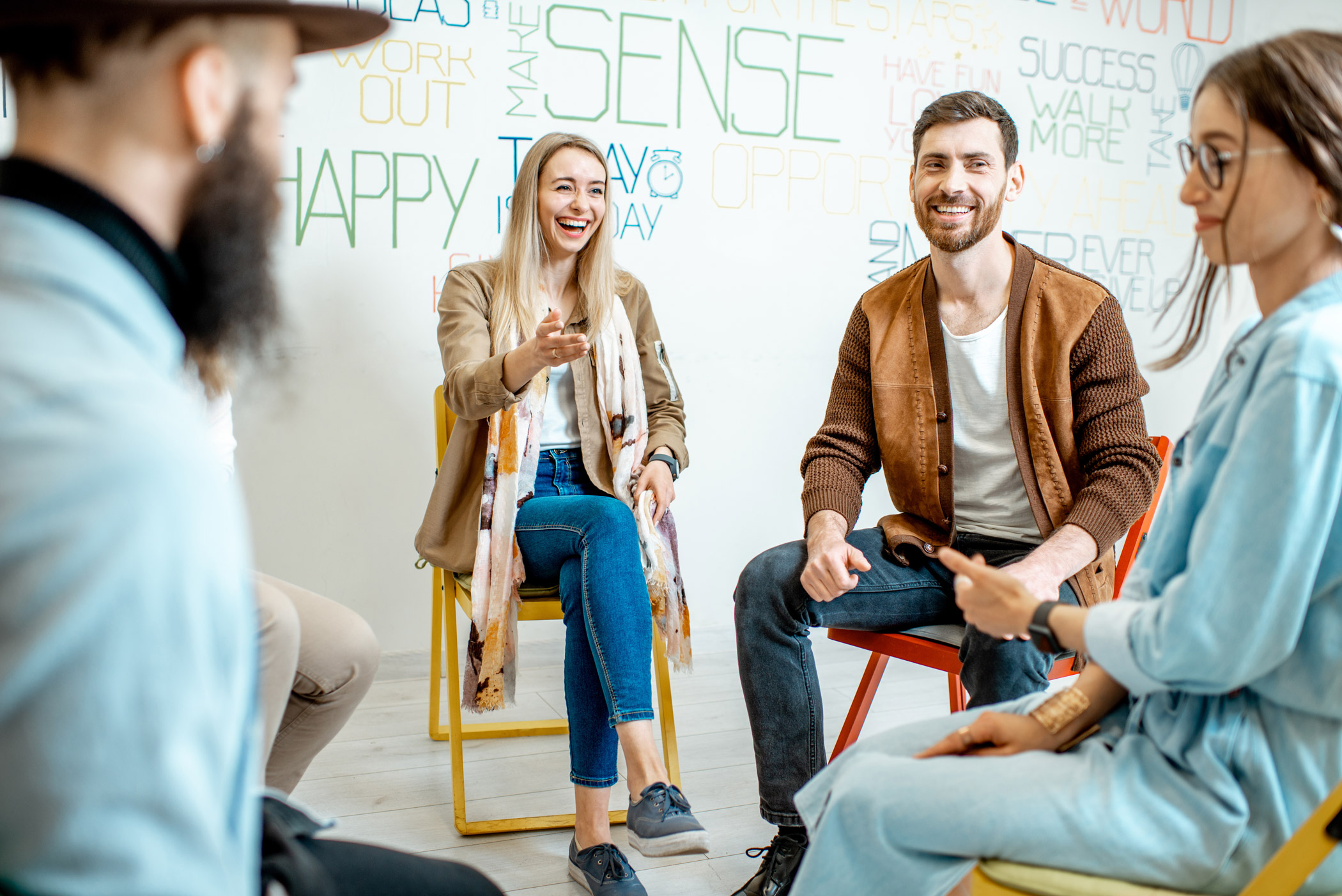 A group of people sat together in a circle and talking