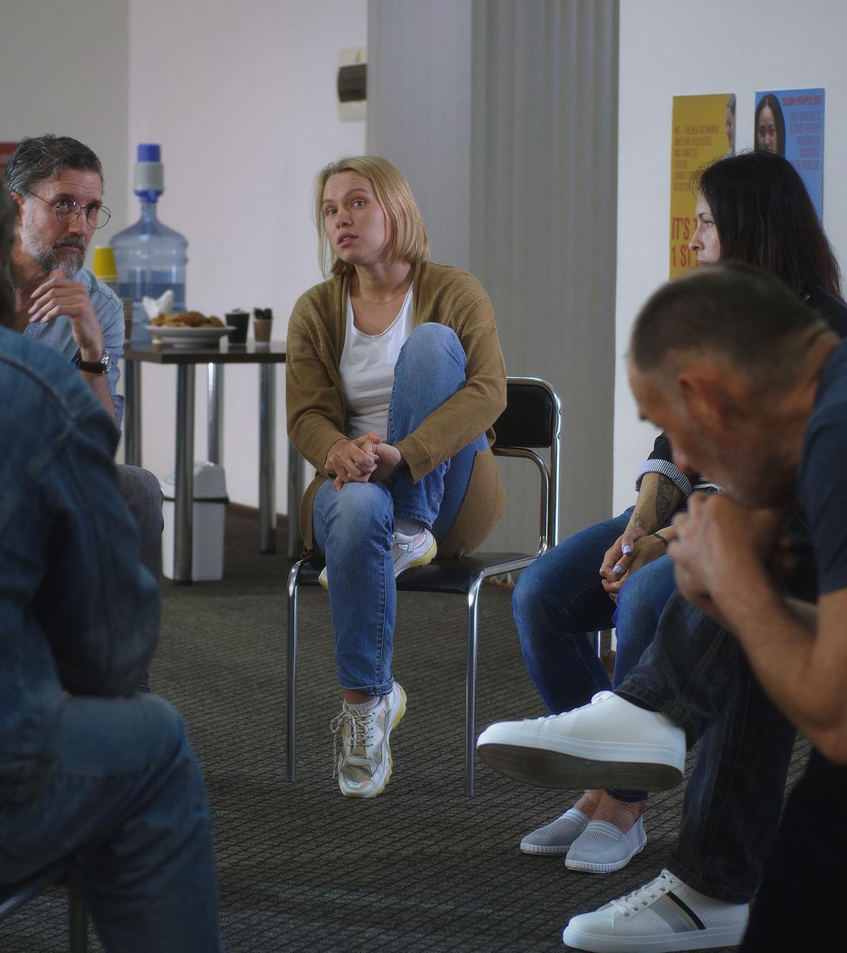 A group therapy session with people discussing emotional experiences, representing the practical learning focus of a DProf in Trauma Psychology, Online course in Trauma Psychology, and Trauma Therapy Courses.