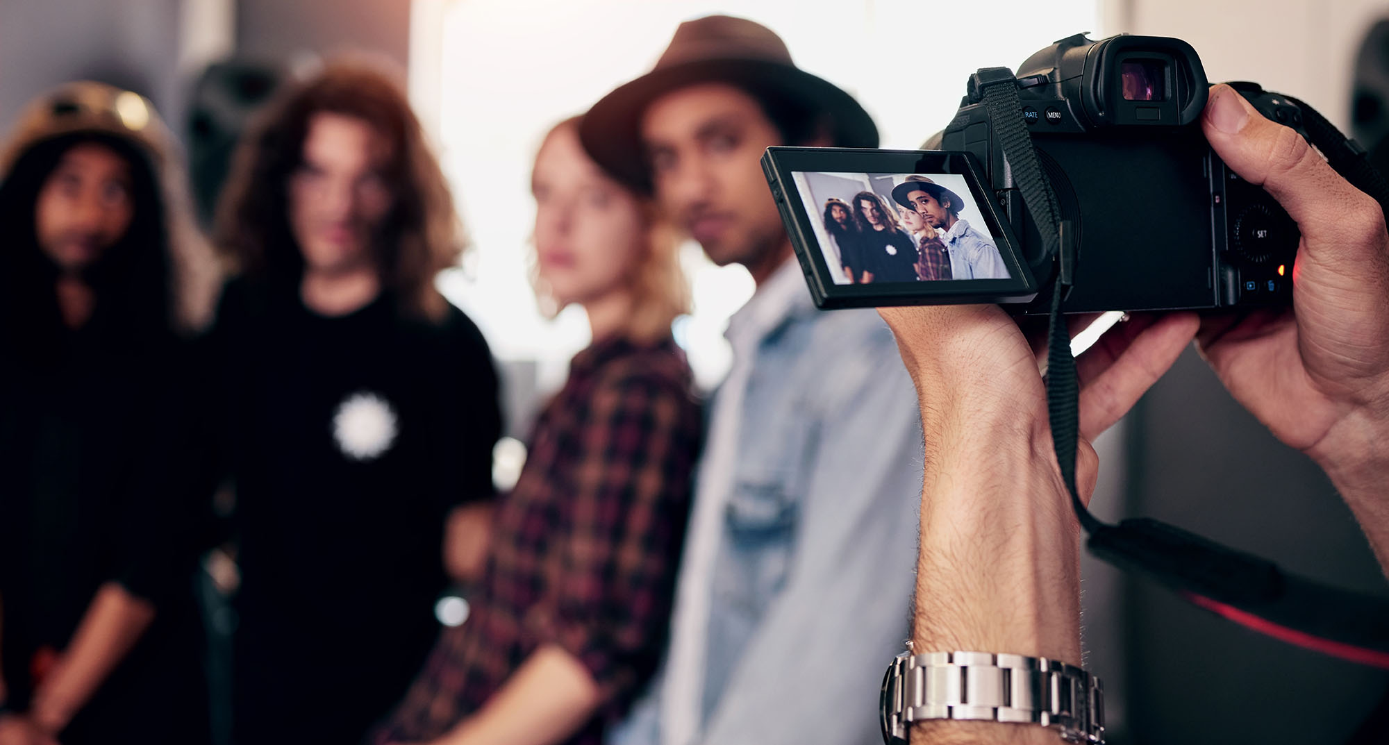 Cropped shot of the paparazzi snapping pics of the band backstage