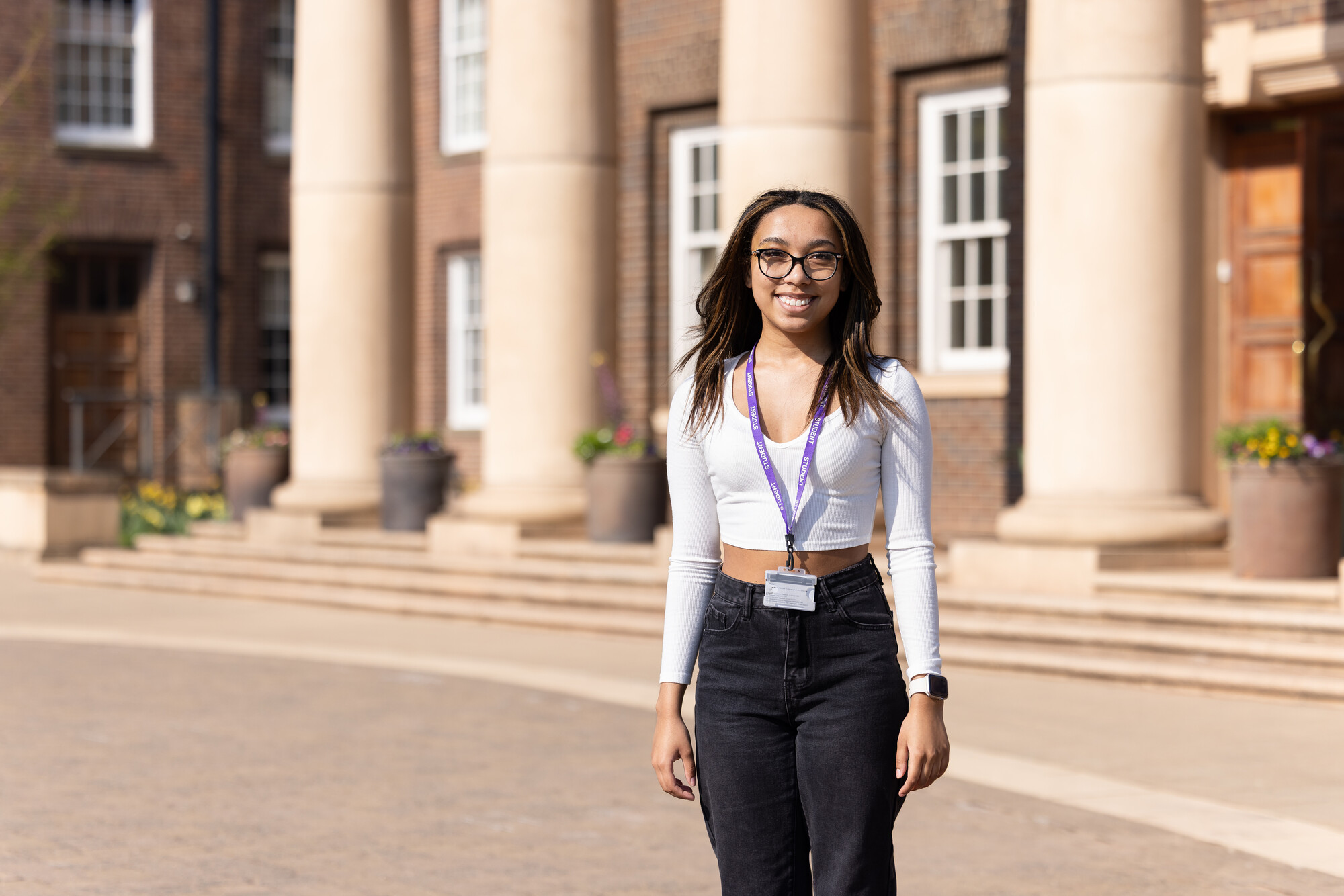 A student standing outside of Queens Park campus