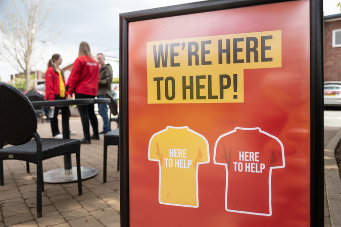 A sign saying 'we are here to help'