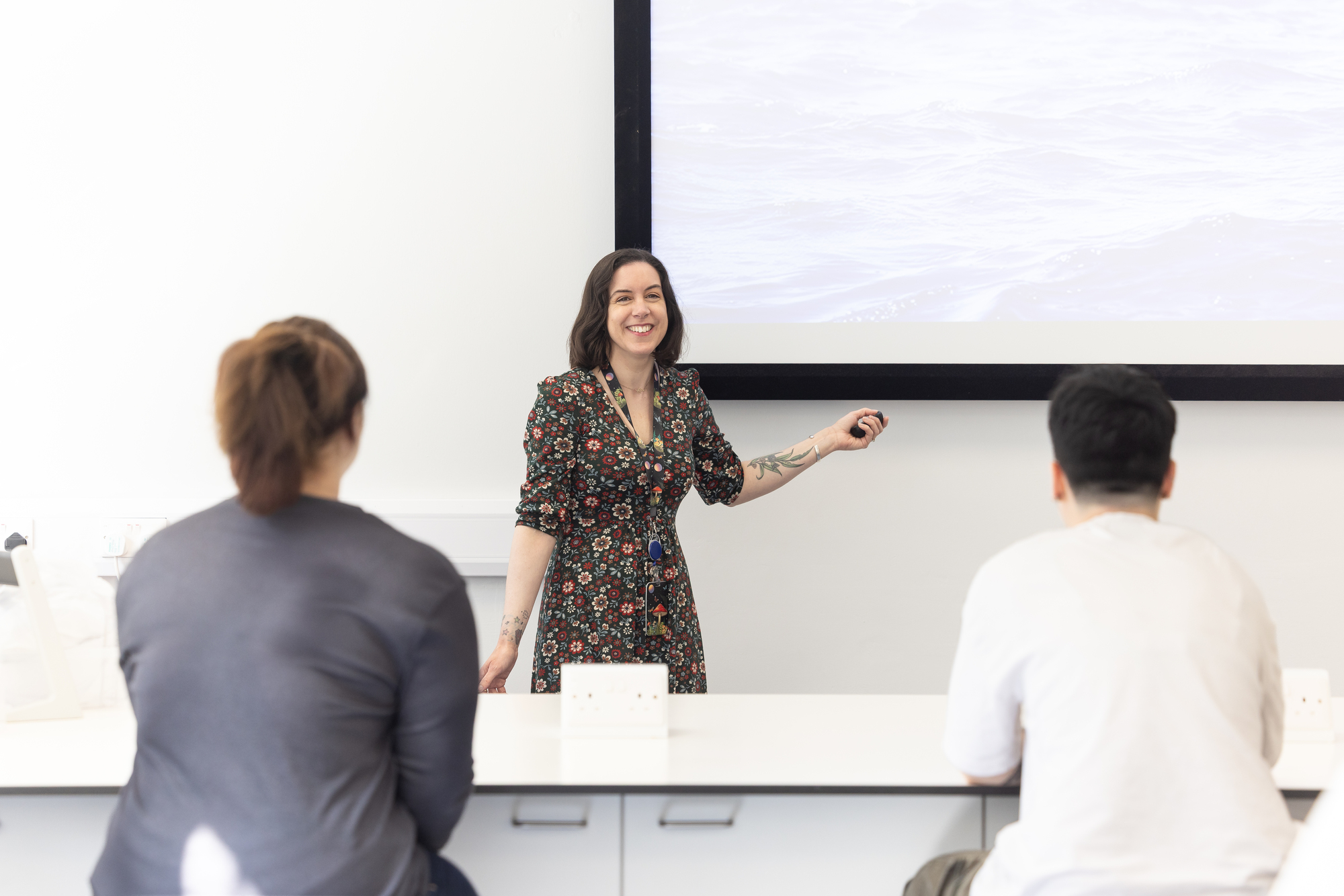 Dr Jodie Gruber teaching in front of two students in a lecture theatre