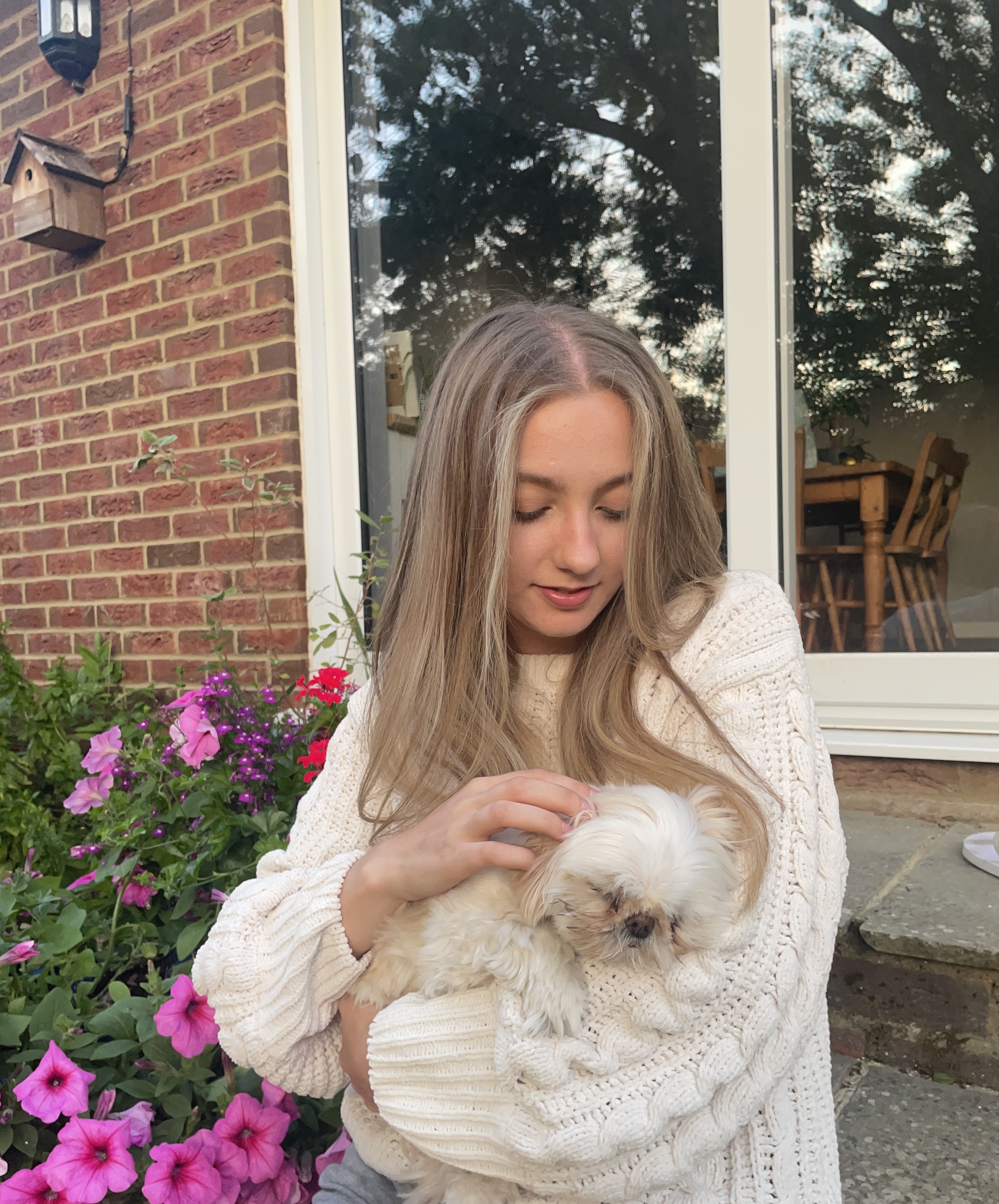 Isabel Hatcher holding and stroking a dog